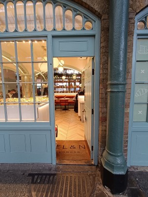 Blue door with silver, metal knob on left ahead. Push to open.