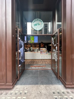 Double glass doors with brown frame. Vertical silver metal handles in middle. Pull to open.