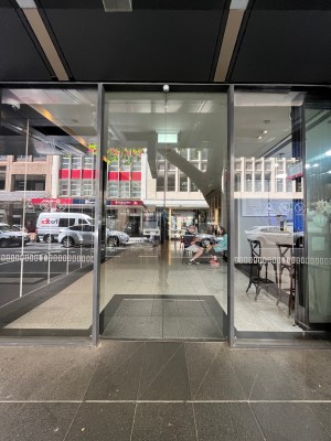 Glass double doors slide open automatically from middle.