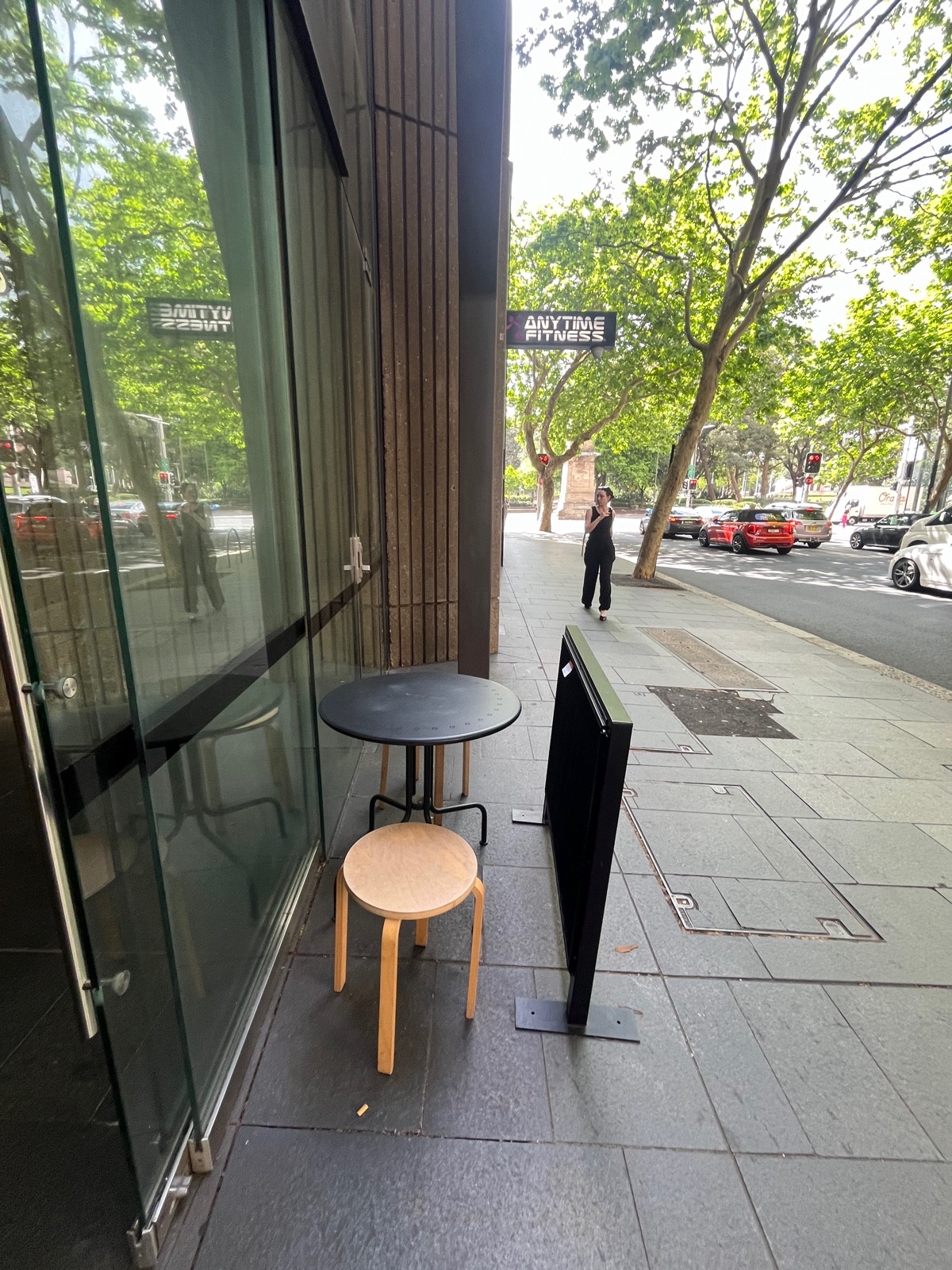 From door facing left. Table with backless stools immediately ahead. Divider to right.