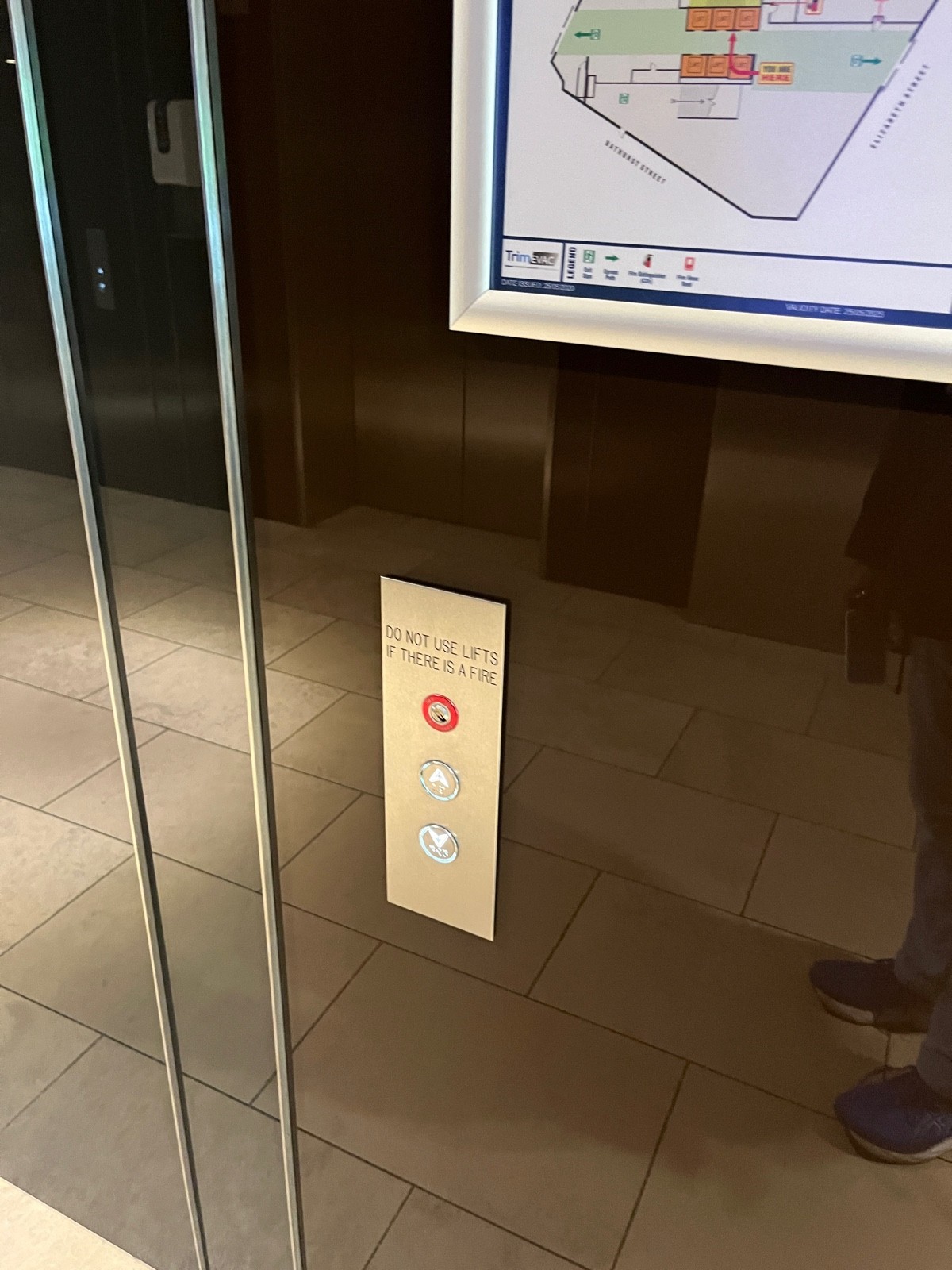 Lift call button to left of lift. Press down button for bathrooms.