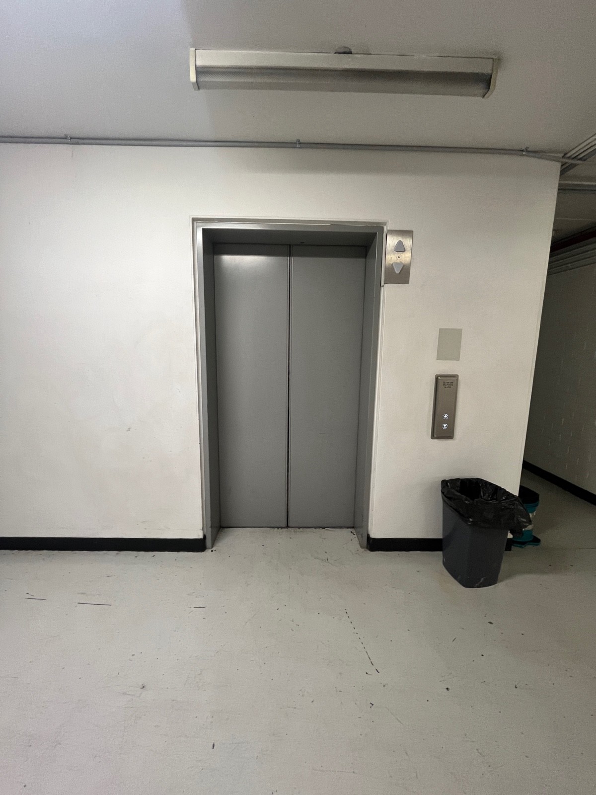 From lift exit facing straight. Path to bathroom continues right.