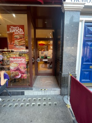 From street, facing venue. One step up ahead before door.