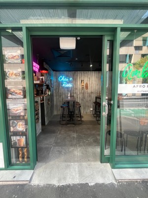 Glass door with green metal frame. Slide open to right. Built in ramp up through door.