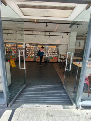 Facing entrance door. Push silver metal handles in centre of door to open.