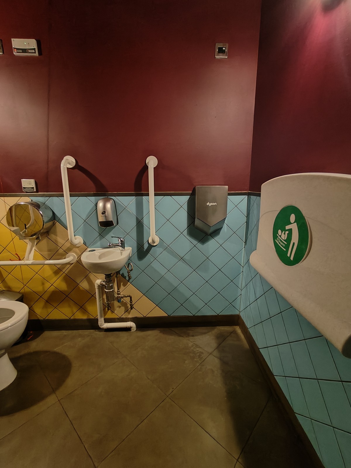 From door facing straight. Baby change table on right. Sink at back left.