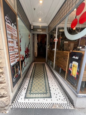 Open archway with built in ramp leading to door.
