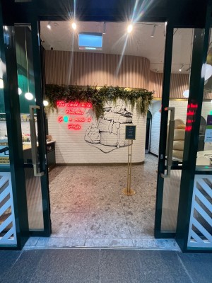 Glass double doors with green metal frames. Doors slide open manually from middle.