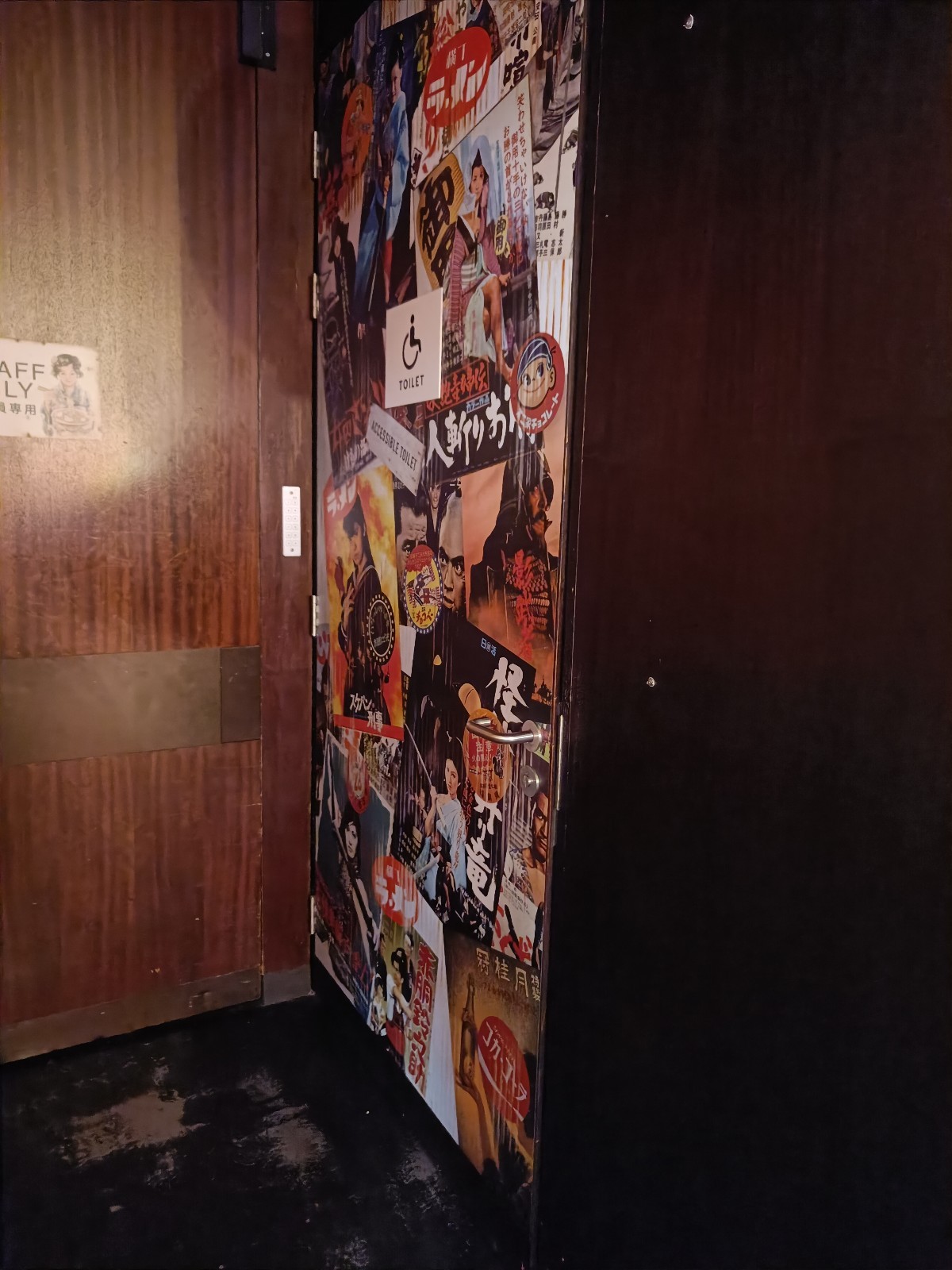 From path, looking right. Patterned door ahead. Silver, metal handle on right. Pull to open.