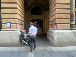 Open archway leading to kiosk service counter. Seating obstructing on left side of archway.