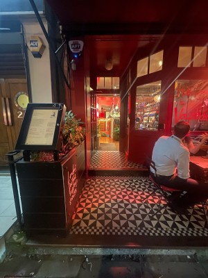 From street, facing venue. Step up for outdoor seating ahead.