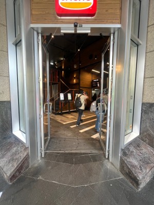 Glass double doors with silver metal frame. Push from middle.