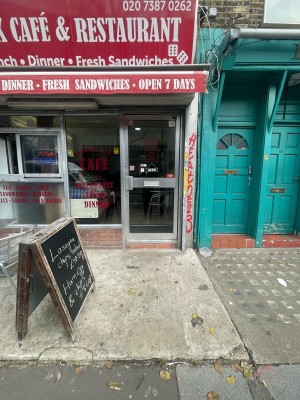 From street, facing venue. Step up before door for outdoor seating and to access venue ahead.