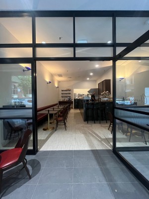 Glass double doors with black metal frame. Turn black handles and pull from middle.