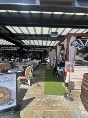 Open archway to venue through outdoor front seating either side.