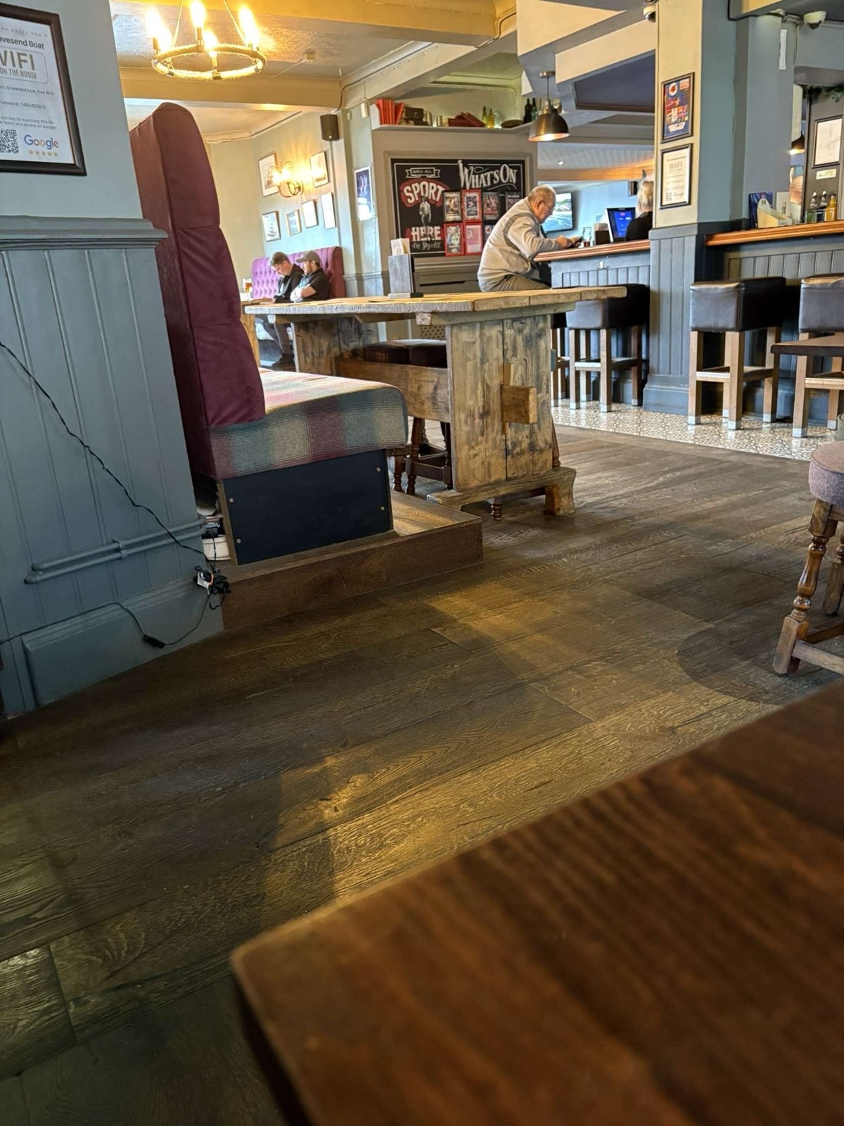 Spacious walkway with sofa style seating with high table within close proximity to the bar