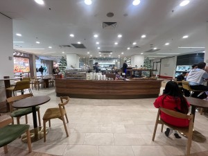 Open archway to kiosk counter through seating either side.