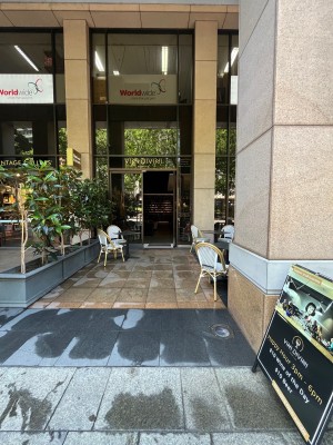 Open archway to venue through outdoor front seating. Door directly ahead.