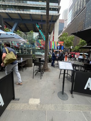 Open archway to venue. Path continues left through outdoor front seating.