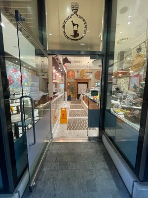 Glass door ahead. Silver metal handle to right. Pull to open.