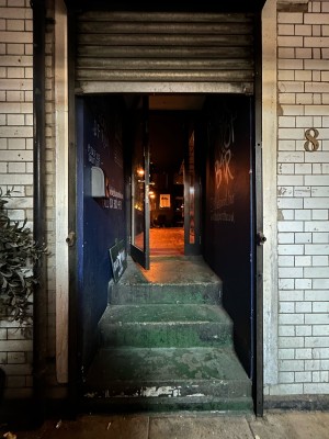 Open archway then steps up to main entrance door.