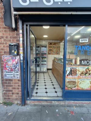 Blue-framed glass door ahead. Push blue metal handle on right to open.