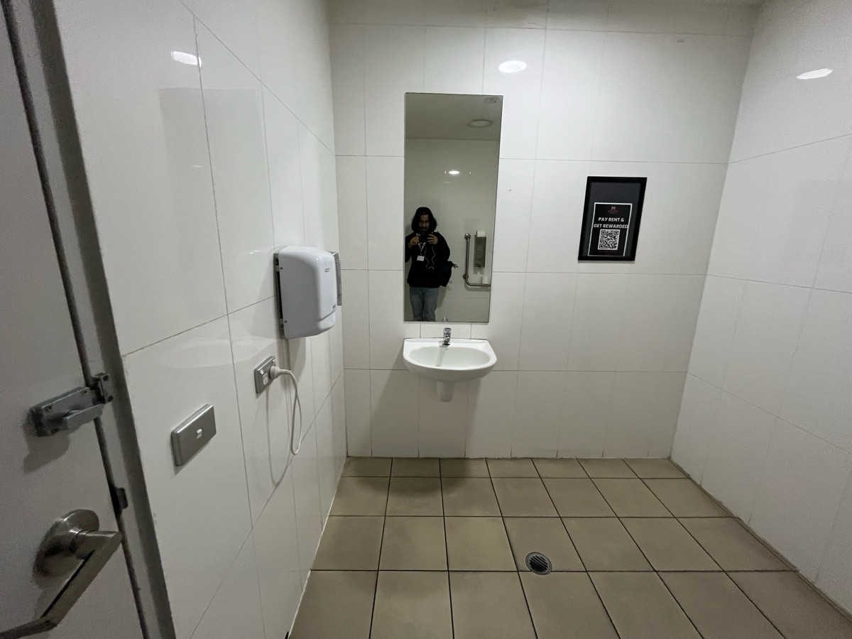 From door facing left. Sink on wall ahead.