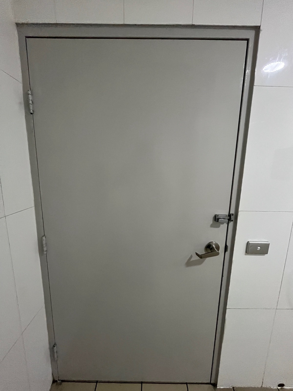 Back of door. Turn lock on right above handle. Light switch on wall to right.