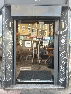 Glass doors with silver, metal handles in middle. Push to open.