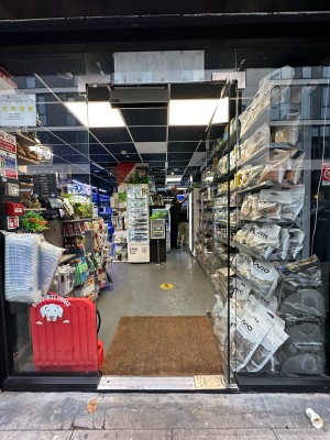 Glass door. Handle on left, push to open.