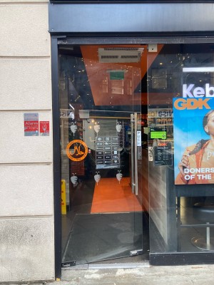 Glass door ahead. Push to open via metal hand rail on right.