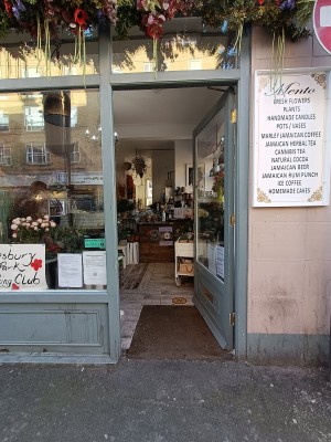 Glass door with grey frame. Push from left to open.