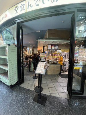 Glass double doors with black frame slide open from middle. Divider in middle separating seating area from service area. Doors typically open.