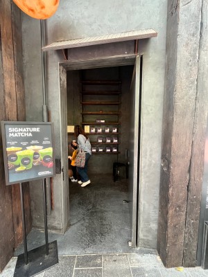 Brown wooden door. Push from left. Door typically kept open.