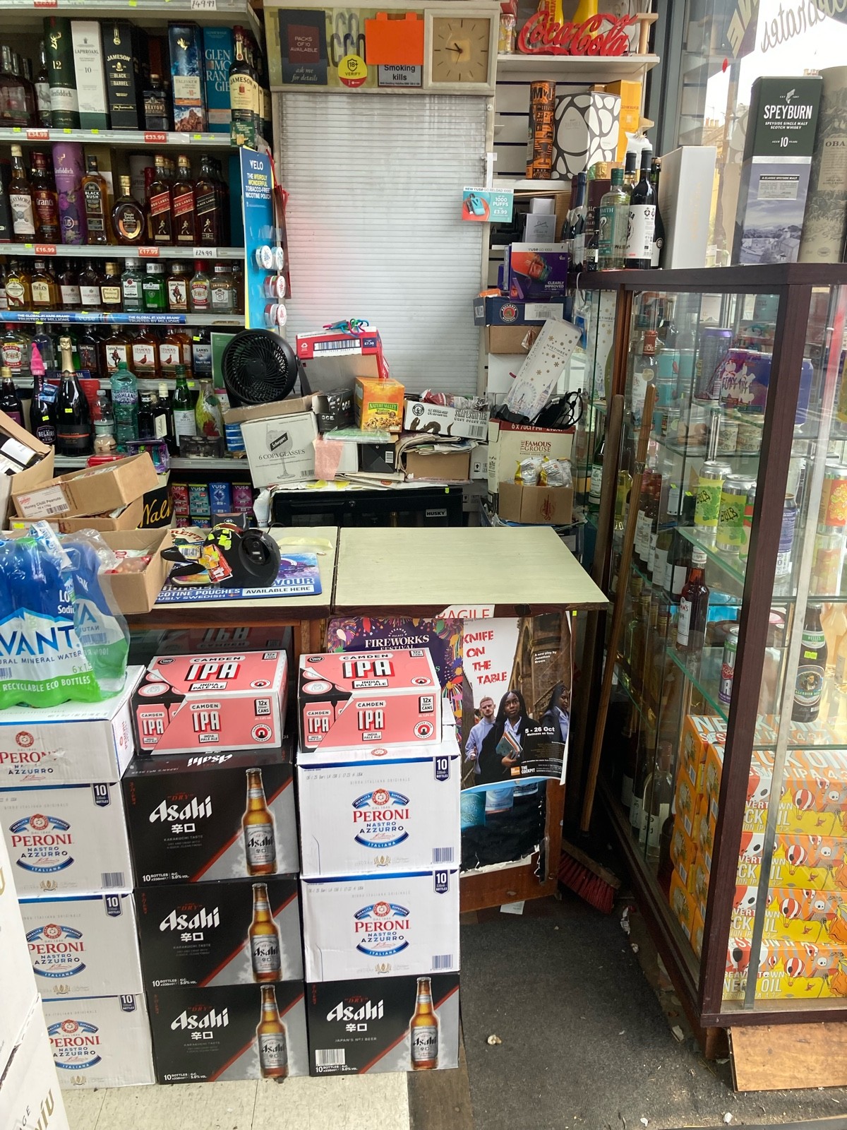 From entrance, facing right. Product shelves ahead, counter behind.