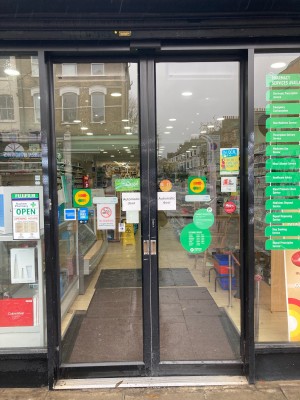 Glass doors ahead with black frame. Doors slide to open automatically.