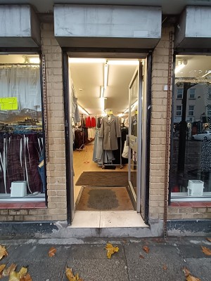 Glass door with silver, metal handle on left. Push to open.