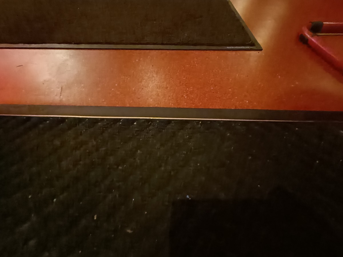 Doormat and raised edge after doorway.