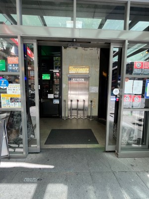 Glass doors with grey metal frame. Doors slide open from middle.