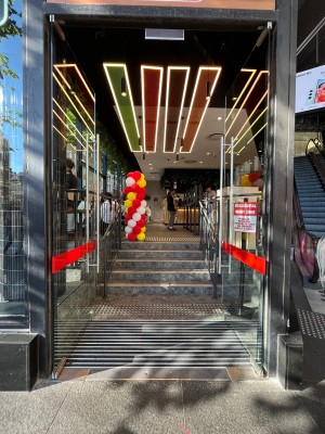 Entrance doors ahead. Push silver metal handles in centre to open.