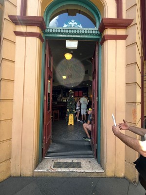 Brown wooden doors with glass panels. Push from middle.
