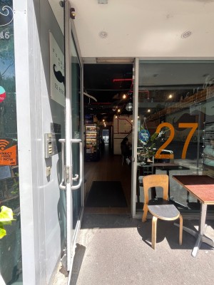 Glass door with silver metal frame. Pull silver handle from right.