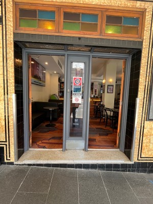 Glass doors with brown wooden frames separated by divider in middle.