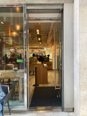 Glass door ahead. Push to open via metal hand rail on left.