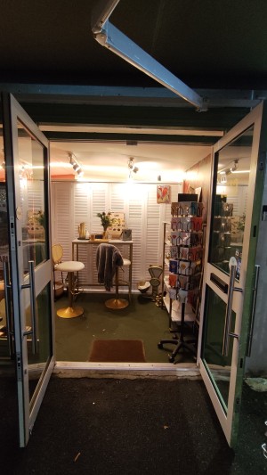 From pavement facing venue. Glass doors with green and white frames ahead. Pull metal handles in centre to open.