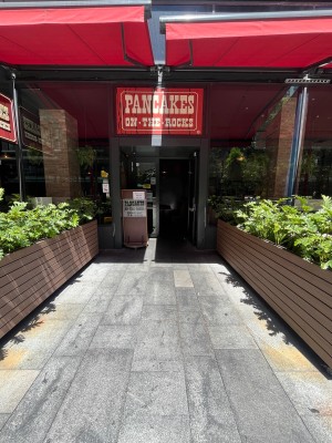 Path to entrance. Dividers either side. Doors ahead.