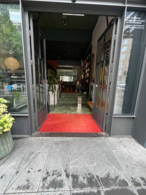 Glass doors with grey metal frame open inwards from middle.