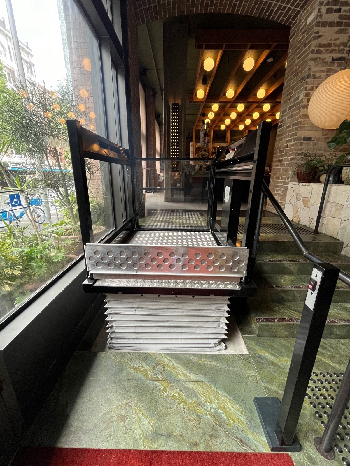 Platform lift. Call button to right.