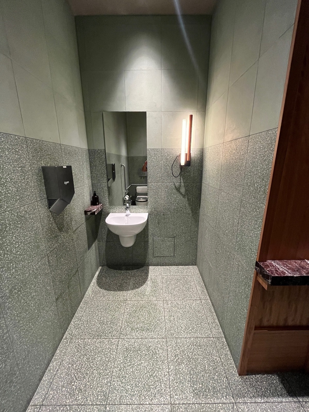 From toilet facing right. Sink on wall ahead to left.