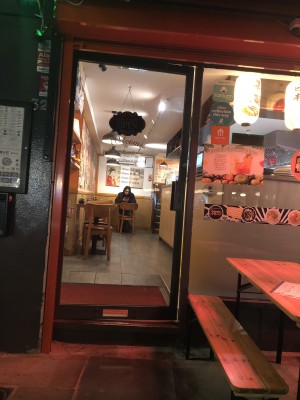 Black framed glass door, push grey metal handle on right to open